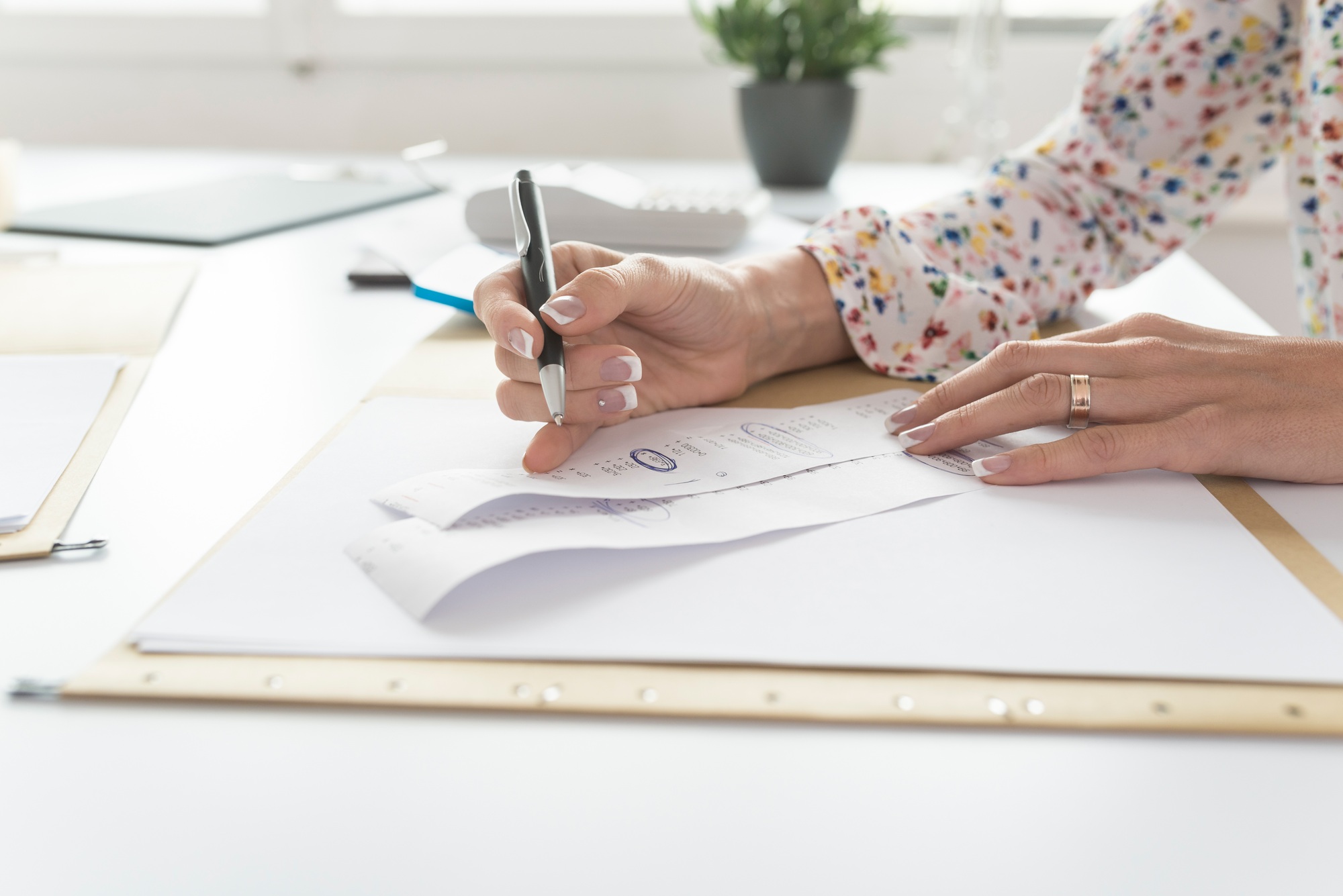 Accountant or financial adviser checking and comparing receipts while making a final report